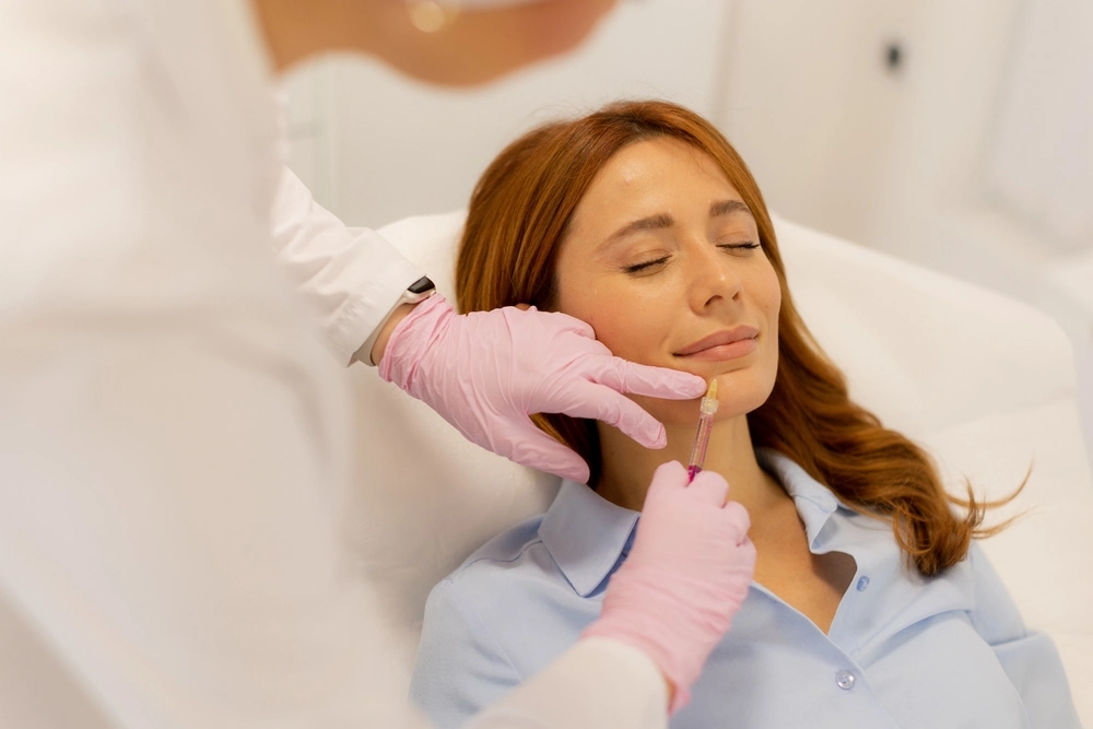 Doctor adding lip filler - facial aesthetics